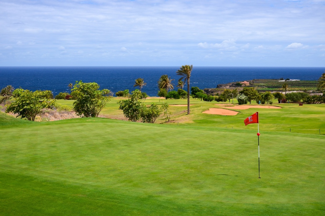 Flag on green grass in golf course of Buenavista del Norte, Tenerife, Canary Islands 